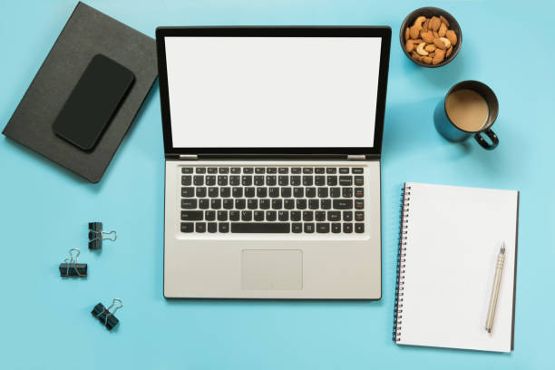 istock Workplace with open laptop, accessory on office blue table. Top view and copy space. 1031960240