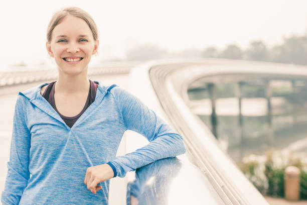 istock Smiling Sporty Attractive Woman on Bridge 1031960384