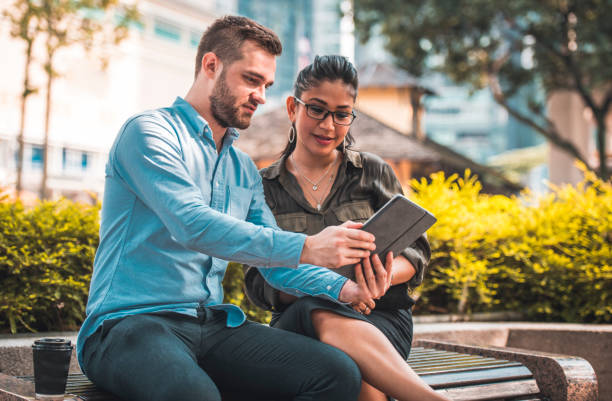 istock Business couple discussing over digital tablet 1031963306