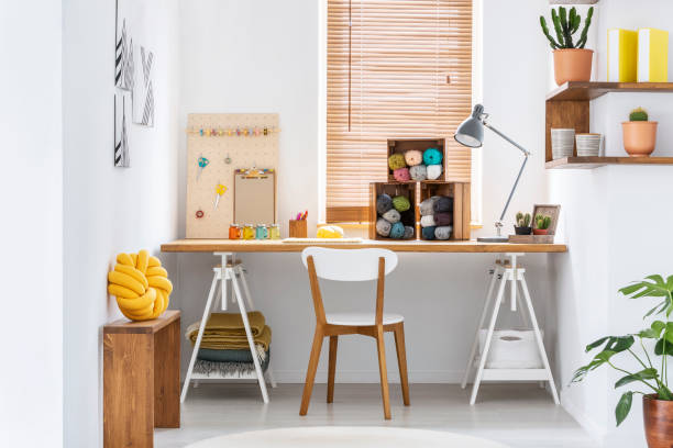 istock Scandinavian style hobby room interior with workspace for knitting, sewing, crocheting and designing handmade home textiles. Real photo. 1031970432