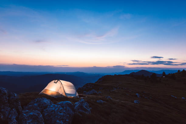 istock View of a tent in the mountains at night 1031972996
