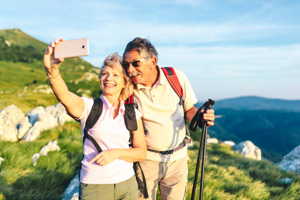 istock Senior couple taking a selfie on their hike in the mountains 1031973078
