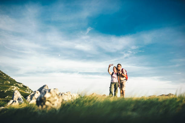 istock Active senior couple hiking and taking a selfie 1031973108