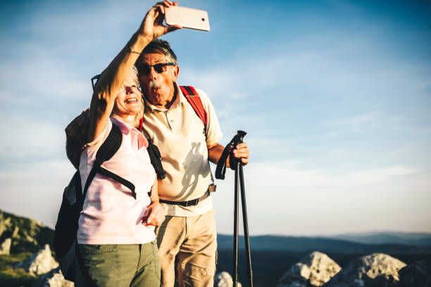 istock Active senior couple hiking and taking a selfie 1031973122