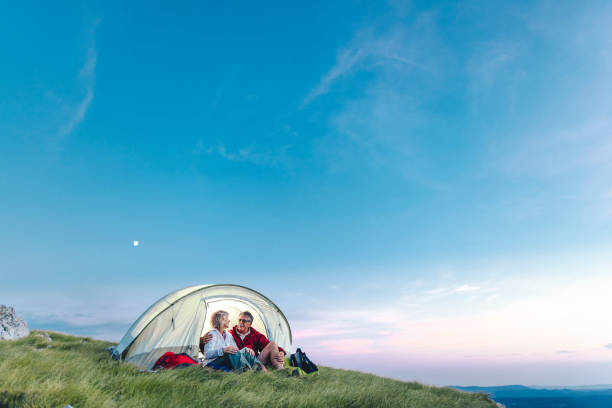istock Happy senior couple camping in the mountains 1031973214