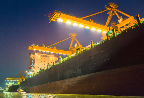 istock Container Cargo freight ship with working crane bridge in shipyard in singapore 1031997642