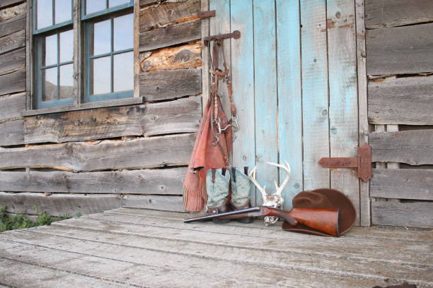 A grouping of Old West themed items against a turquoise colored door.