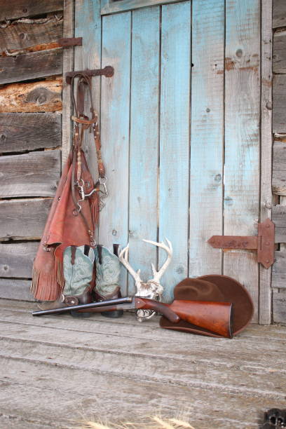 istock A grouping of Old West themed items against a turquoise colored door. 1032004756