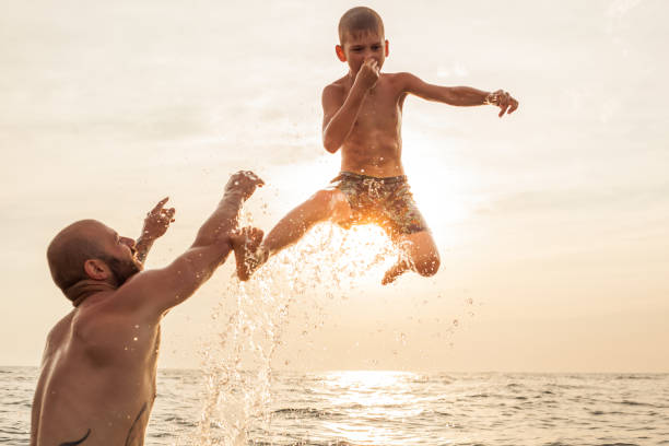 istock Father and son enjoying summer holidays at the beach 1032006582