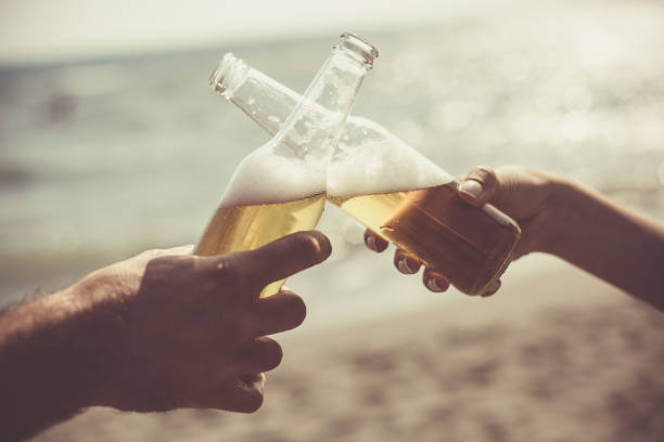 istock Friends toasting with beer bottles at the beach 1032009068