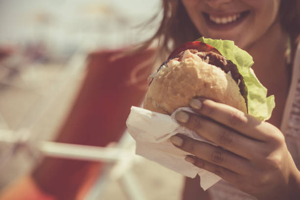 istock Woman eating outdoors 1032012028