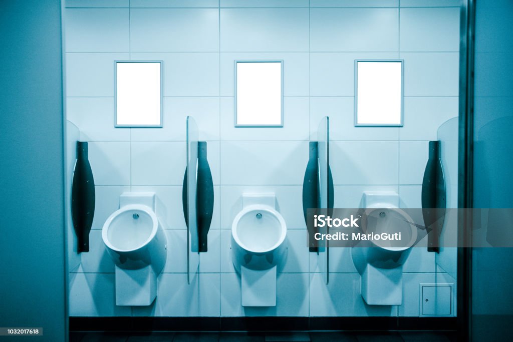 Blank billboards at public toilet Some blank billboards inside a public toilet Urinal Stock Photo