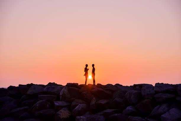 istock a man and a woman on sunset background 1032018076