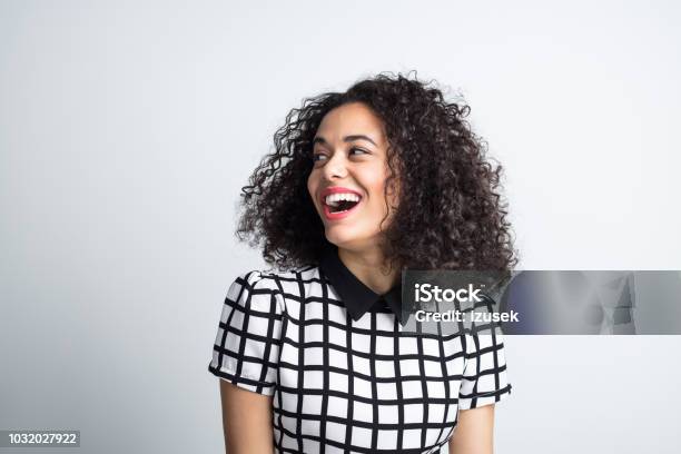 Cute Woman Looking Away And Laughing Stock Photo - Download Image Now - Women, One Woman Only, Laughing