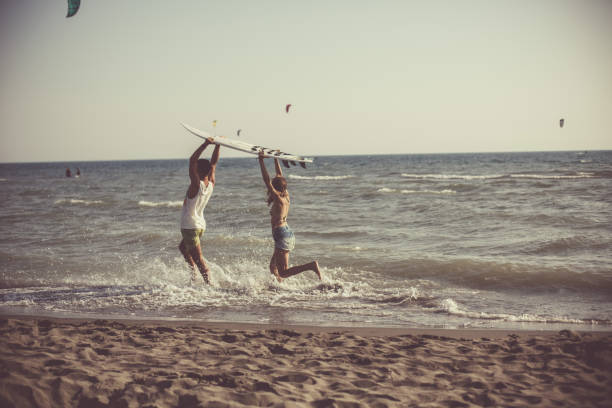 istock Surf couple at the beach 1032028280