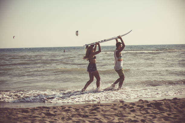 istock Surf couple at the beach 1032028282