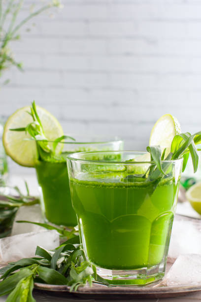 istock Homemade lemonade from fresh tarthun with lime in glass glasses, selective focus 1032028398
