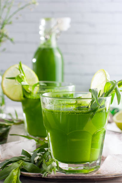istock Homemade lemonade from fresh tarthun with lime in glass glasses, selective focus 1032028410
