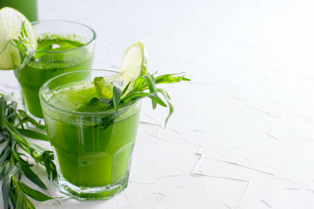 istock Homemade lemonade from fresh tarthun with lime in glass glasses, selective focus 1032028454