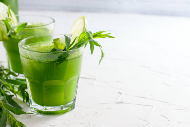 istock Homemade lemonade from fresh tarthun with lime in glass glasses, selective focus 1032028468