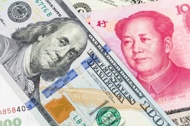 istock US Dollar and Chinese Yuan banknote money 1032031382