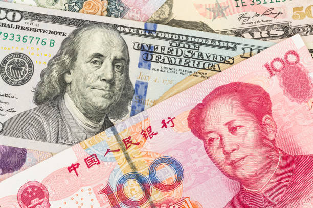 istock US Dollar and Chinese Yuan banknote money 1032031390