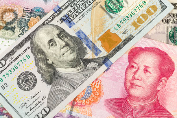 istock US Dollar and Chinese Yuan banknote money 1032031406