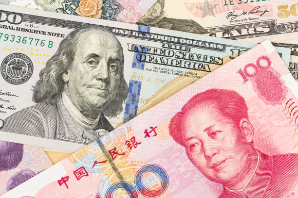 istock US Dollar and Chinese Yuan banknote money 1032031436