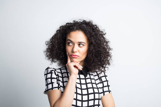 istock Thoughtful woman looking away on gray background 1032033002