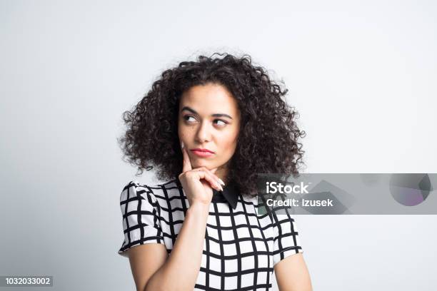 Thoughtful Woman Looking Away On Gray Background Stock Photo - Download Image Now - Asking, Curiosity, One Person