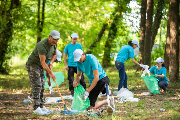 istock Young man with prosthetic leg cleaning the park 1032033460