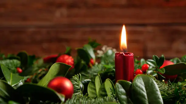 Photo of Seasonal advent wreath of fir twigs and mistletoes with candlelight and baubles