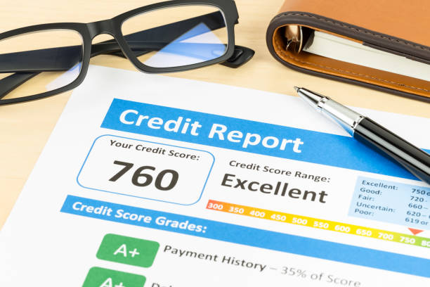 istock Credit score report with pen, glasses, and organizer book 1032034826