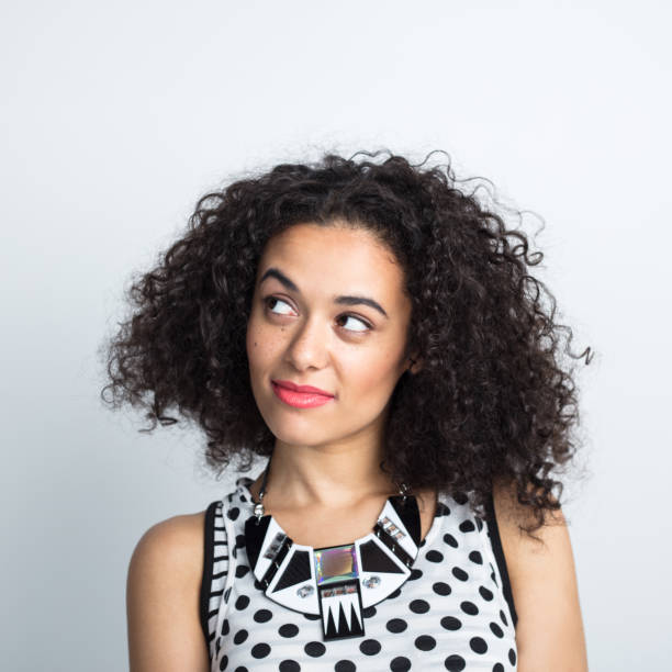 istock Curly hair woman staring at copy space 1032039422