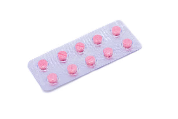 istock Pink pills in a package isolated on a white background 1032039512