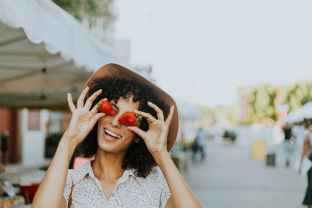 istock Woman having fun with strawberries 1032040610