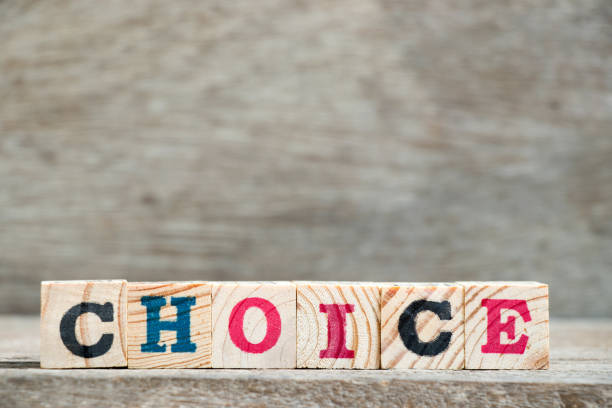 istock Letter block in word choice on wood background 1032040908