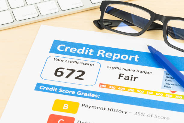 istock Fair credit score report with pen and keyboard; document is mock-up 1032041394