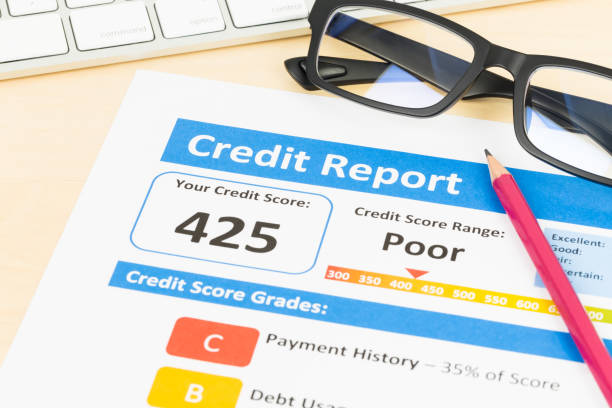 istock Poor credit score report with pen and keyboard; report is mock-up 1032041464