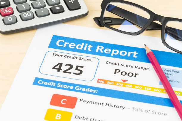 istock Poor credit score report with pen and calculator 1032041494