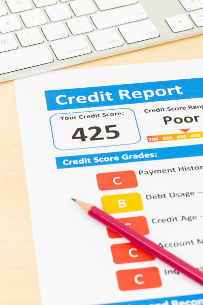 istock Poor credit score report with pen and keyboard 1032041496
