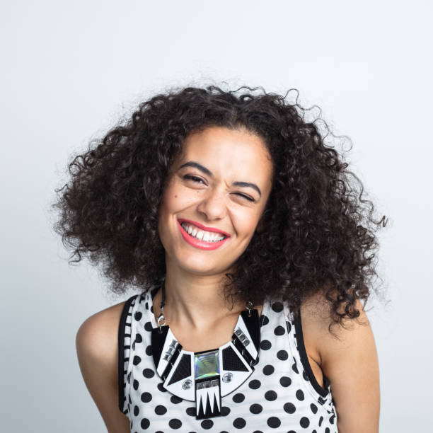 istock Cute woman winking with beautiful smile 1032044100