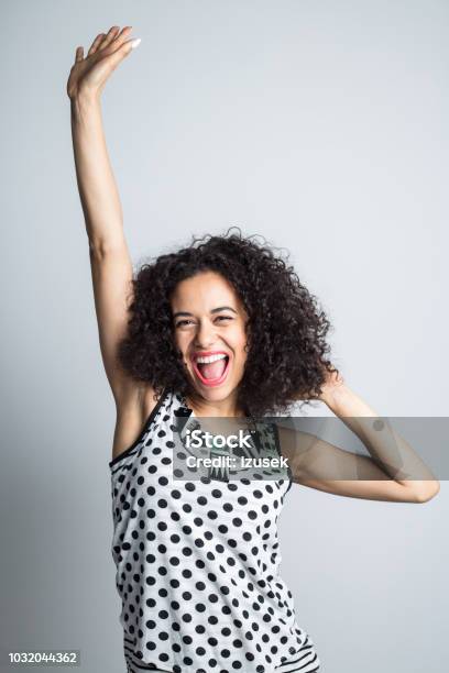Energetic Woman Celebrating Success Stock Photo - Download Image Now - Glamour, Hand Raised, One Person