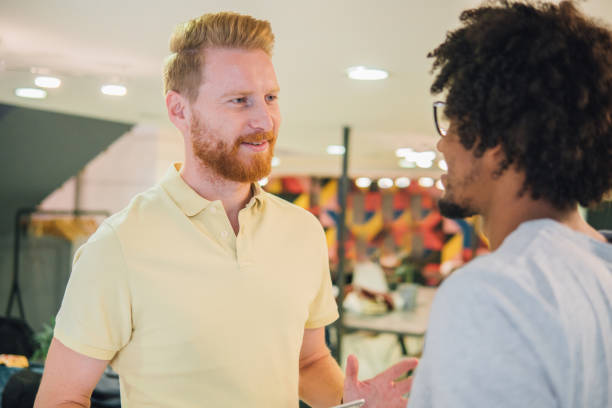 istock Joyful coworkers talking and smiling 1032044984
