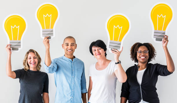 istock People carrying light bulb icons 1032048198