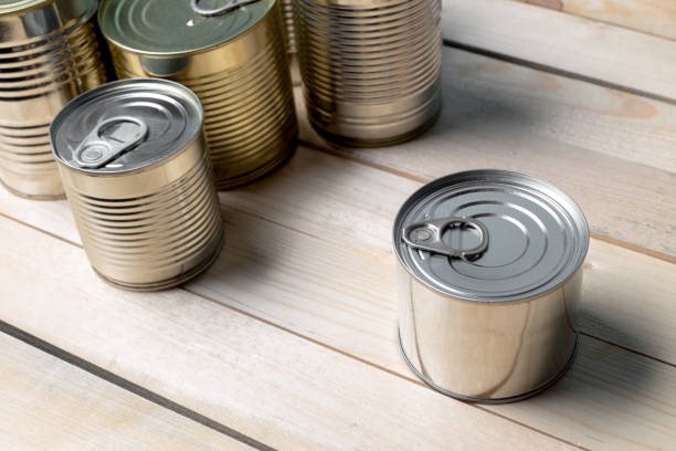 istock Tin cans for food on wooden background 1032054488
