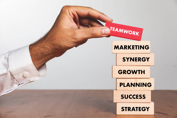 istock Businessman Building TEAMWORK concept with Wooden Blocks 1032057444