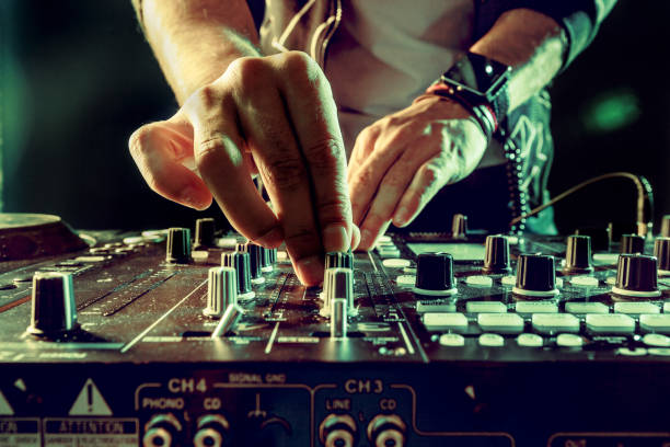 DJ playing music at mixer closeup DJ playing music at mixer closeup dj stock pictures, royalty-free photos & images