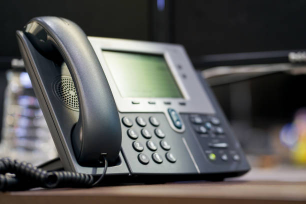close up soft focus on telephone devices at office desk for customer service support concept