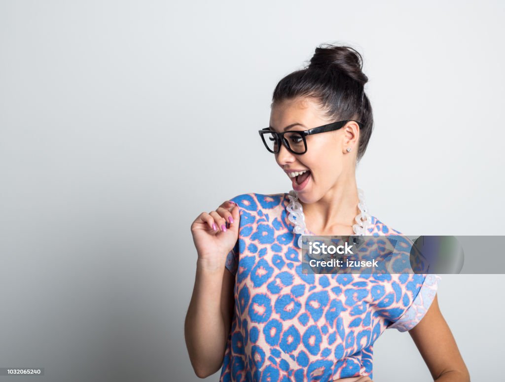 Pretty young woman looking at copy space Portrait of pretty young woman in casuals looking away at copyspace and smiling on white background 20-24 Years Stock Photo